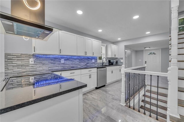 kitchen featuring sink, dishwasher, white cabinetry, island range hood, and decorative backsplash