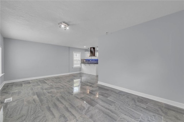 unfurnished room featuring a textured ceiling