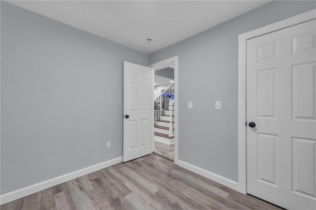 unfurnished bedroom with light wood-type flooring