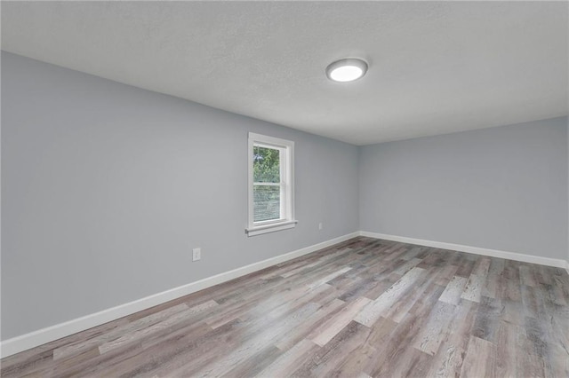 unfurnished room featuring light hardwood / wood-style floors