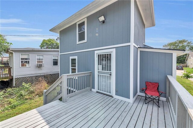 rear view of house featuring a wooden deck