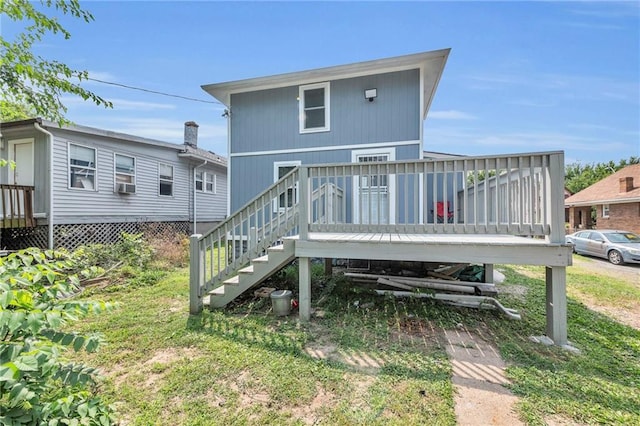 back of property with cooling unit, a lawn, and a deck