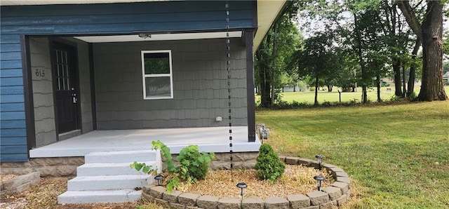 doorway to property with a lawn