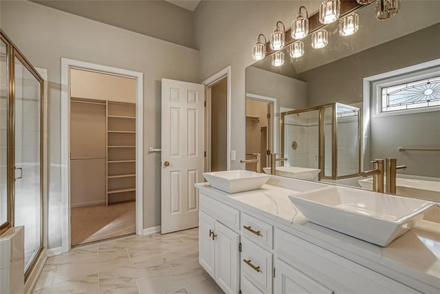 bathroom with vanity and a shower with door