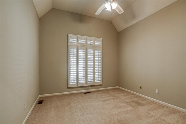 carpeted spare room featuring ceiling fan and lofted ceiling