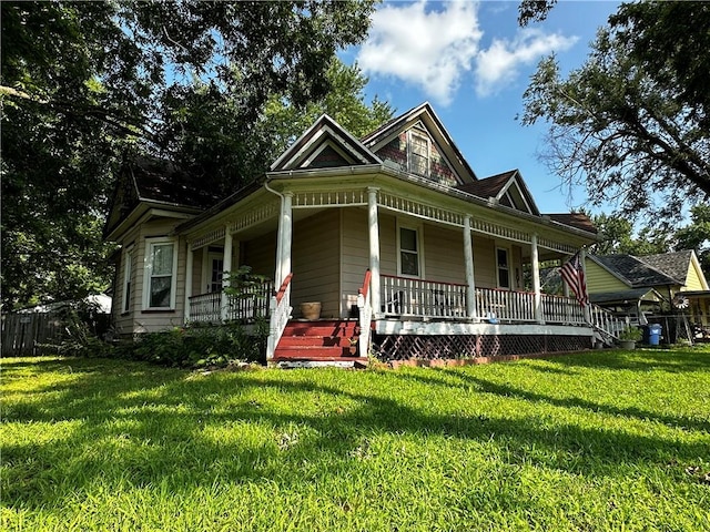 view of front of house with a porch and a front lawn