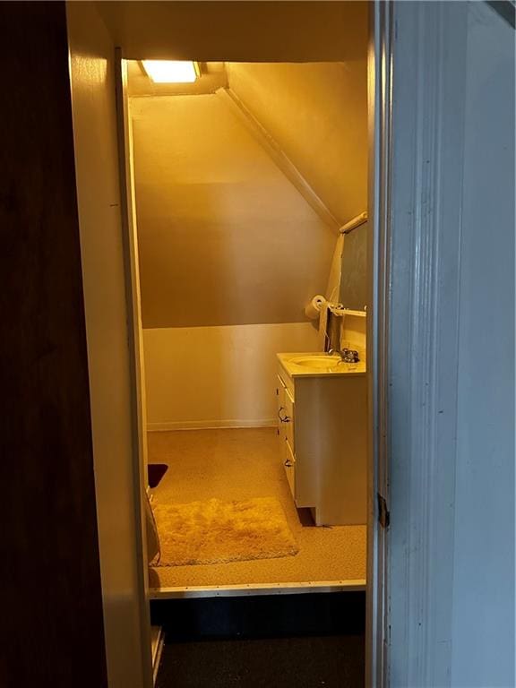 bathroom with vanity and lofted ceiling