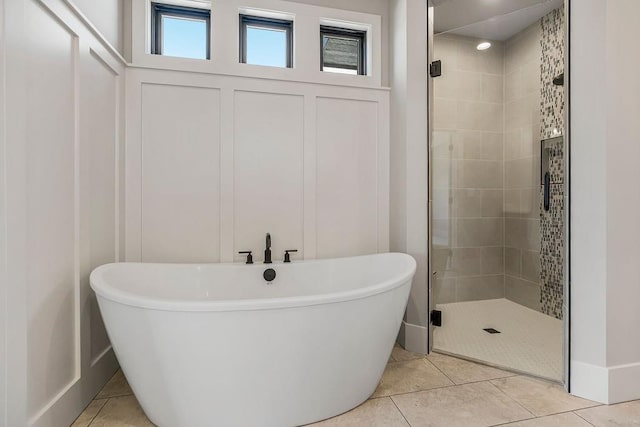 full bathroom with a soaking tub, tile patterned flooring, and a stall shower