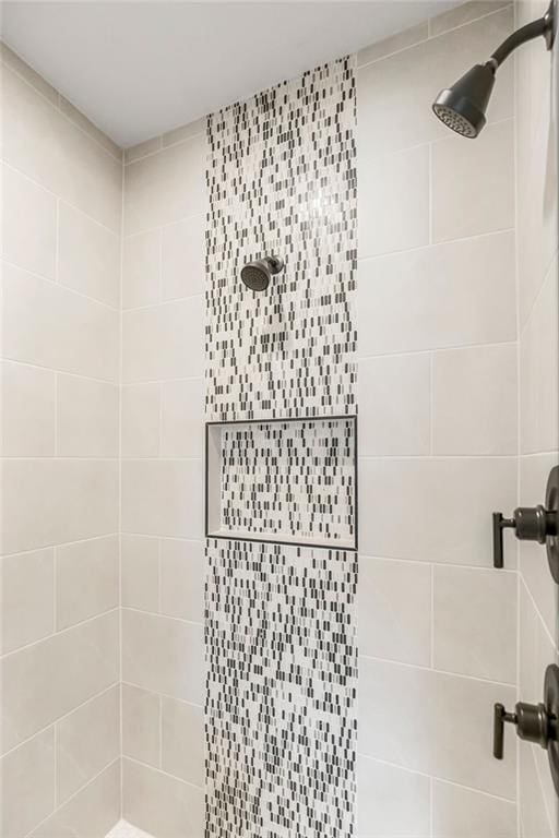 full bath with a tile shower