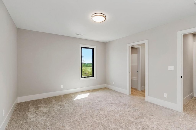unfurnished bedroom with baseboards, visible vents, and carpet flooring