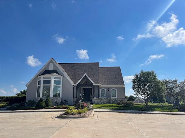 view of front of home with stucco siding and stone siding