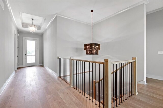 24940 W 98th Pl, Lenexa, KS 66227 - hall with a chandelier, wood finished floors, crown molding, and a tray ceiling