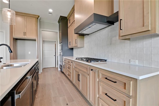24940 W 98th Pl, Lenexa, KS 66227 - kitchen with wall chimney range hood, appliances with stainless steel finishes, light countertops, light wood-style flooring, and crown molding