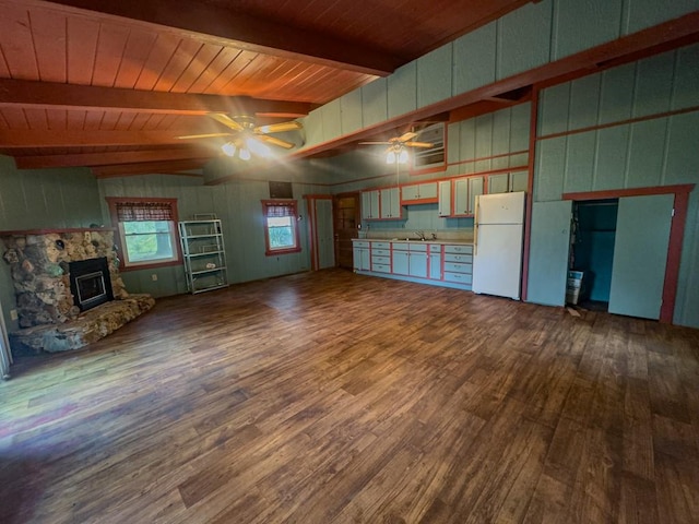 unfurnished living room with beam ceiling, wood-type flooring, a fireplace, high vaulted ceiling, and ceiling fan