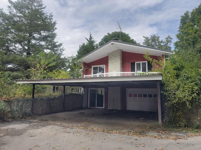 view of property exterior with a garage and a carport