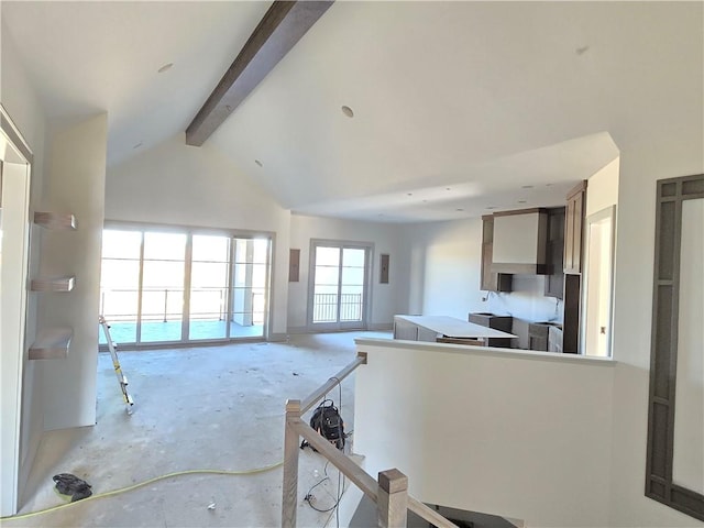 kitchen featuring beam ceiling and high vaulted ceiling