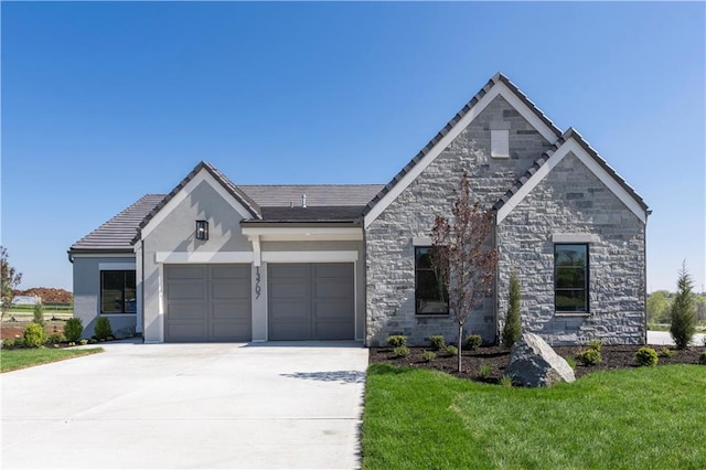 13707 Pembroke Ln, Leawood, KS 66224 - view of front facade featuring driveway, stone siding, a garage, a front yard, and stucco siding