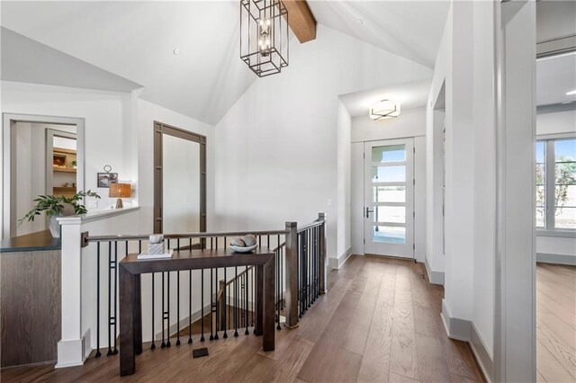 13707 Pembroke Ln, Leawood, KS 66224 - hall featuring beamed ceiling, high vaulted ceiling, an upstairs landing, and wood-type flooring