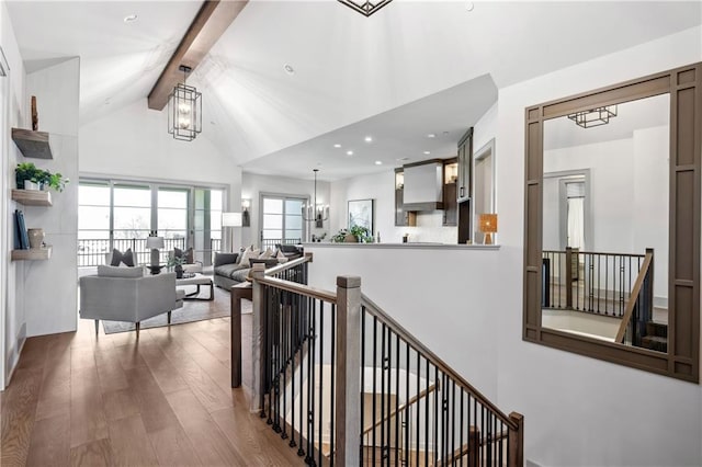 13707 Pembroke Ln, Leawood, KS 66224 - corridor with a chandelier, an upstairs landing, beamed ceiling, wood finished floors, and high vaulted ceiling