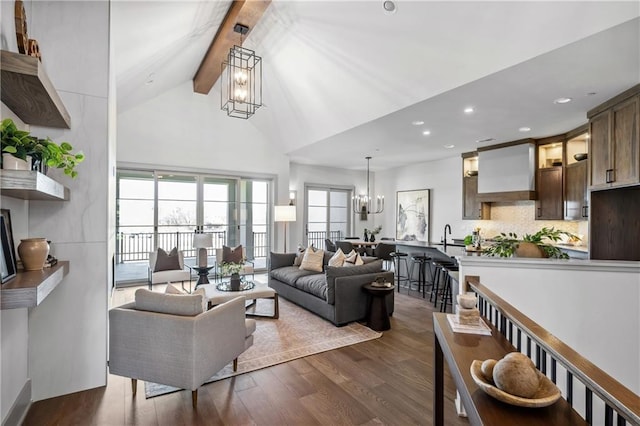 13707 Pembroke Ln, Leawood, KS 66224 - living room with beamed ceiling, dark wood-type flooring, high vaulted ceiling, and a chandelier