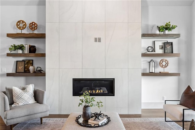 13707 Pembroke Ln, Leawood, KS 66224 - living area featuring wood finished floors and a tiled fireplace