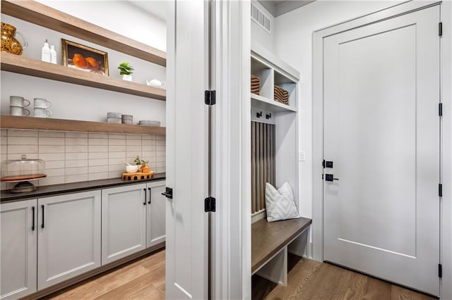 13707 Pembroke Ln, Leawood, KS 66224 - mudroom with light wood-style flooring and visible vents