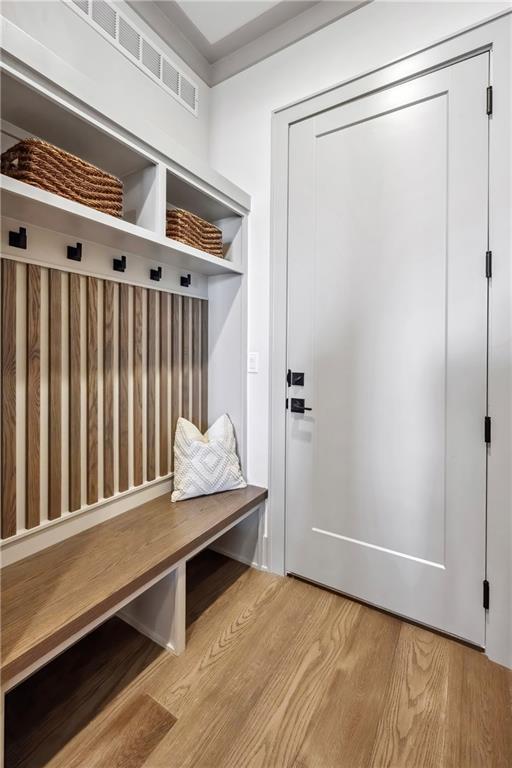13707 Pembroke Ln, Leawood, KS 66224 - mudroom with visible vents and wood finished floors