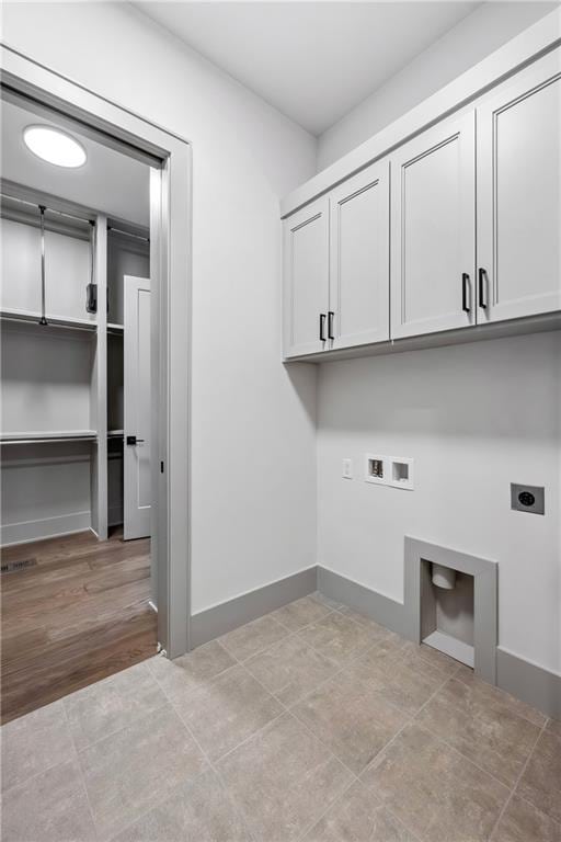 13707 Pembroke Ln, Leawood, KS 66224 - washroom featuring cabinet space, hookup for a washing machine, baseboards, and hookup for an electric dryer