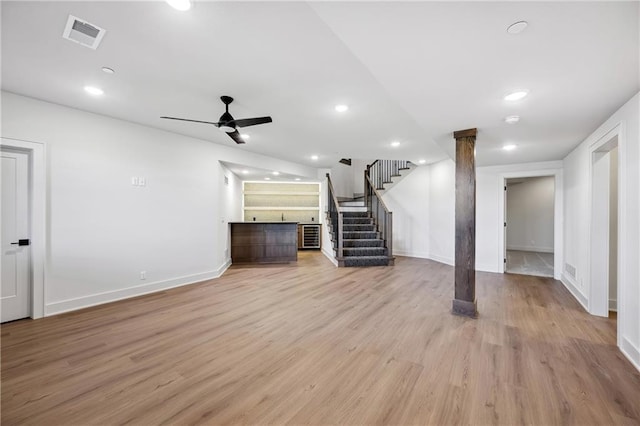 13707 Pembroke Ln, Leawood, KS 66224 - unfurnished living room with stairway, visible vents, light wood-style flooring, and ceiling fan