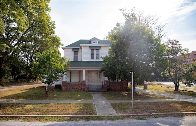 view of front of house with a front yard and a porch