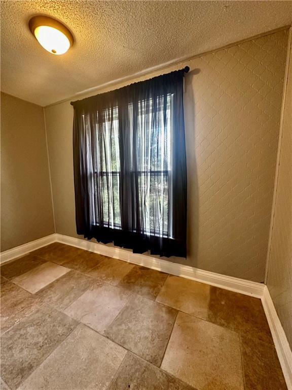 spare room featuring a textured ceiling