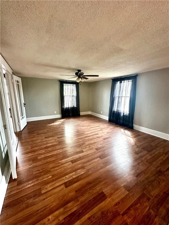 interior space with plenty of natural light and dark hardwood / wood-style flooring