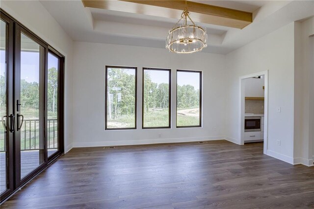 empty room with beamed ceiling, an inviting chandelier, dark wood-type flooring, and a wealth of natural light