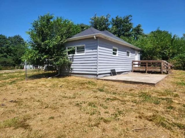 rear view of house featuring a lawn