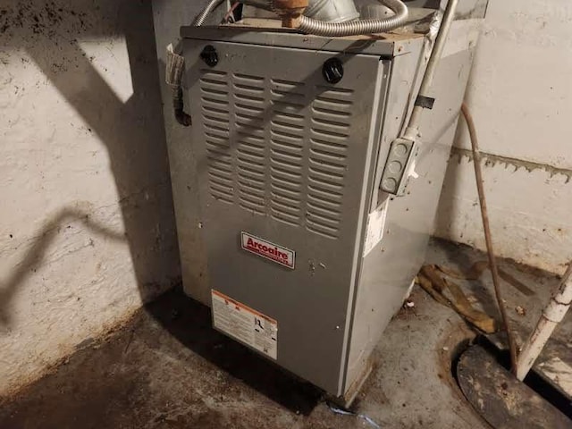 utility room featuring heating unit