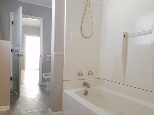 bathroom featuring shower / bathing tub combination, ornamental molding, tile patterned floors, and toilet