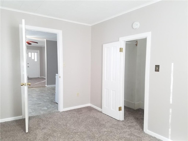 unfurnished bedroom featuring ornamental molding and carpet