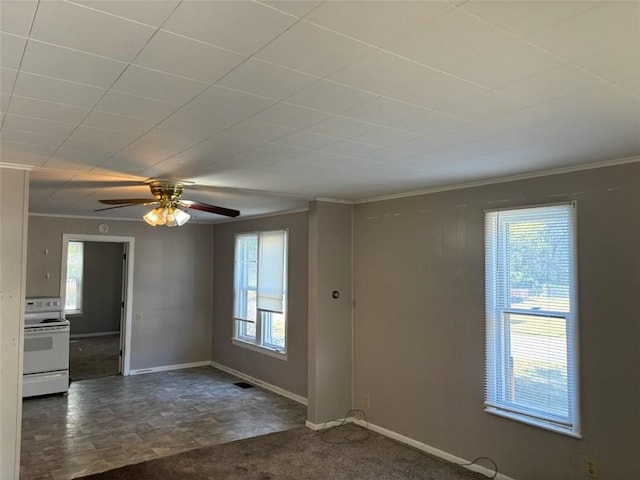 spare room with dark colored carpet and crown molding