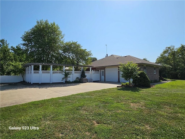 ranch-style house featuring a front yard and a garage