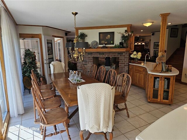 tiled dining area with ornate columns and crown molding