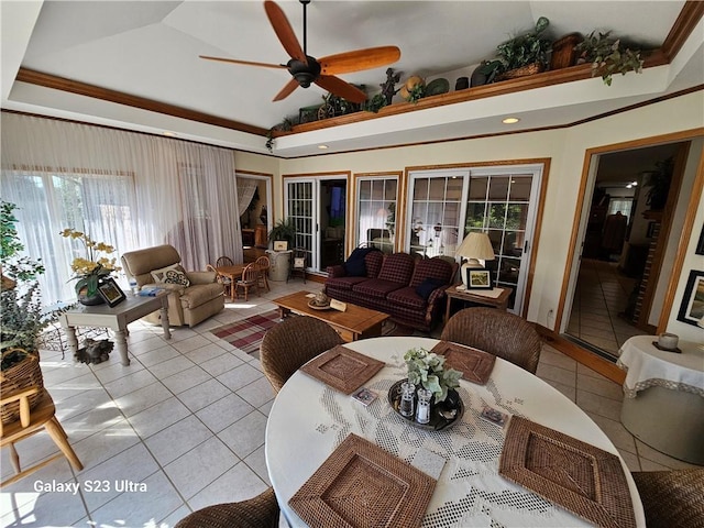 tiled living room with vaulted ceiling, ornamental molding, and ceiling fan