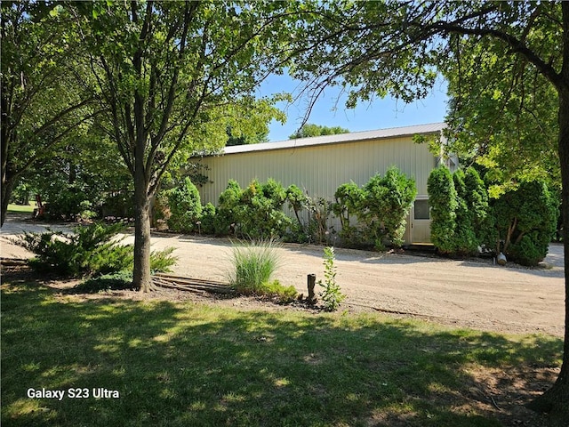 view of property exterior with a lawn