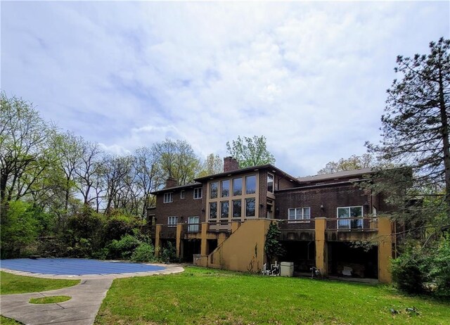 rear view of house with a yard