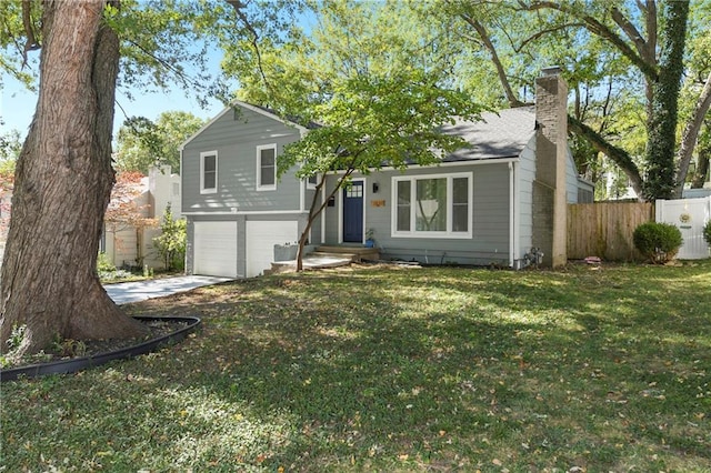 view of front of house with a front yard and a garage