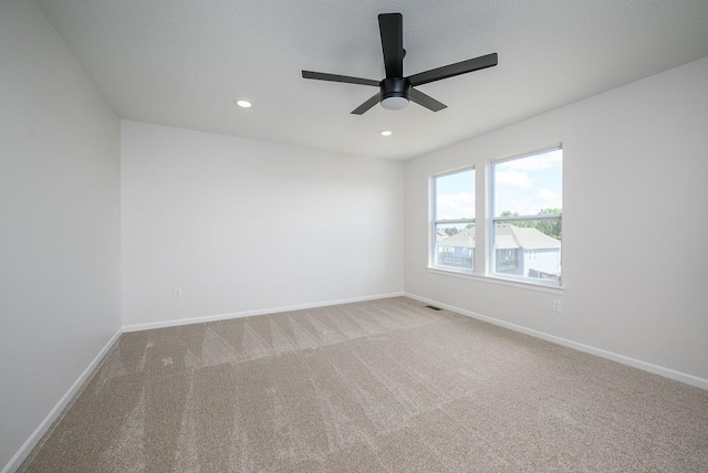 empty room with carpet flooring and ceiling fan