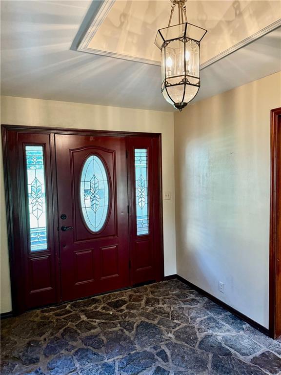 foyer entrance featuring a chandelier