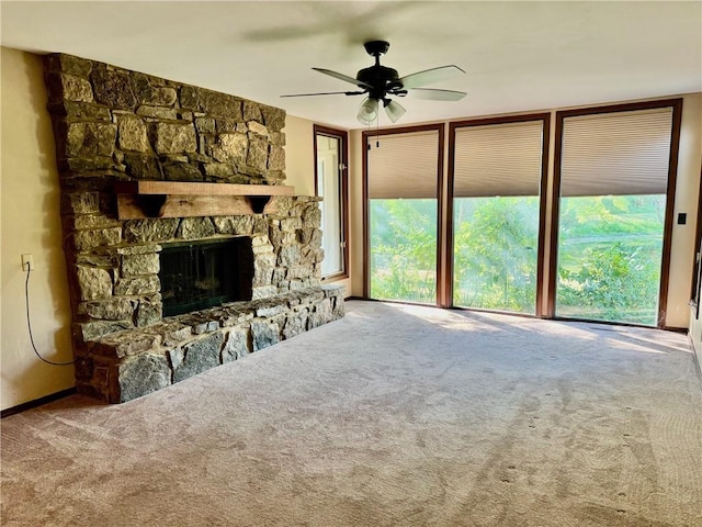 unfurnished living room featuring carpet flooring, ceiling fan, and a fireplace