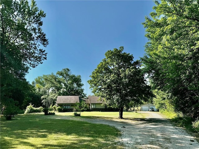 view of community with a yard and a garage