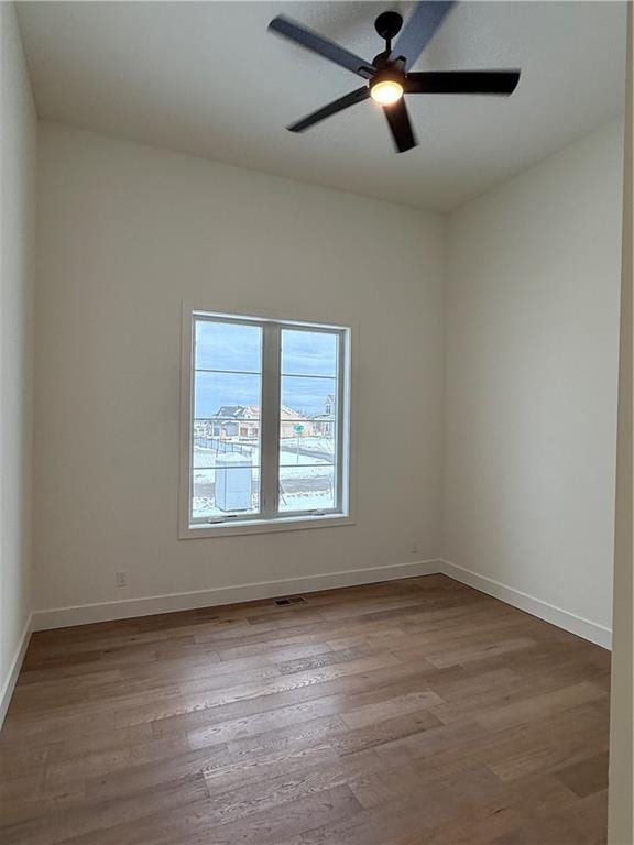 spare room featuring ceiling fan and light wood-type flooring