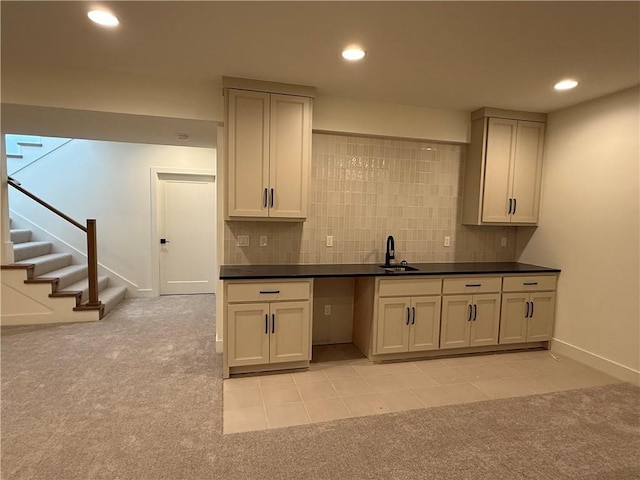 kitchen featuring sink, tasteful backsplash, and light tile patterned flooring